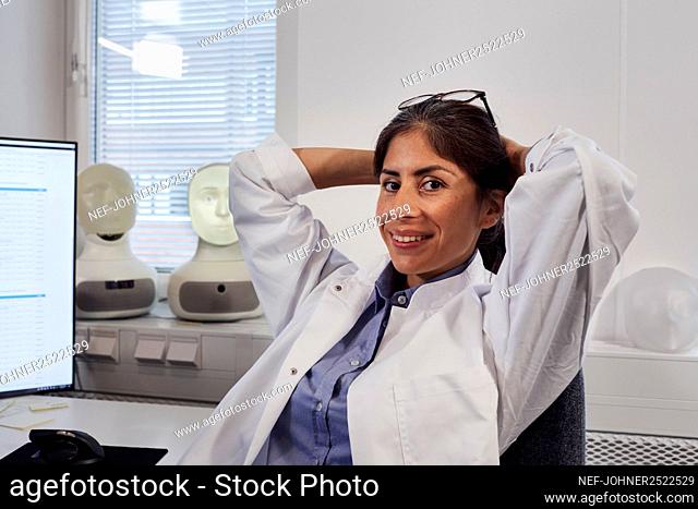 Portrait of female engineer sitting at work station