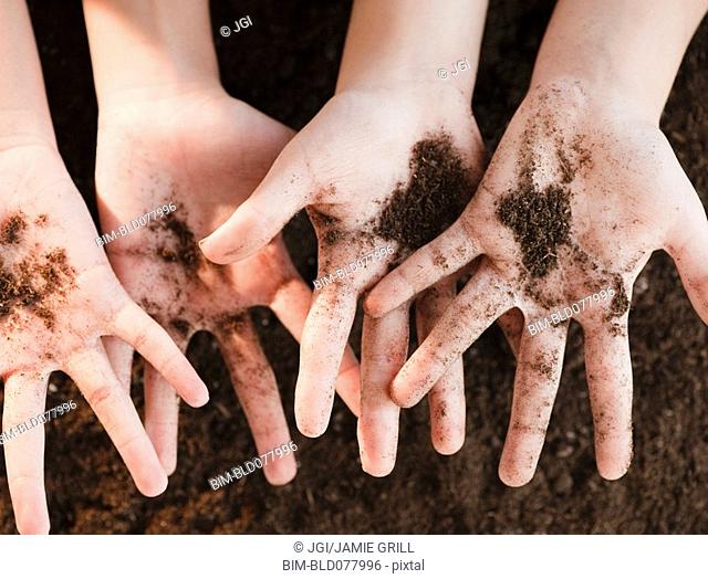 Girls holding dirt
