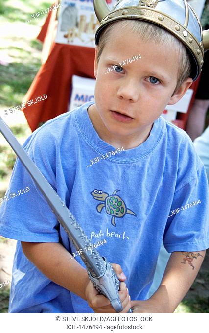 Boy age 5 with Norwegian helmet and sword at Norway Day in Minnehaha Park  Minneapolis Minnesota MN USA
