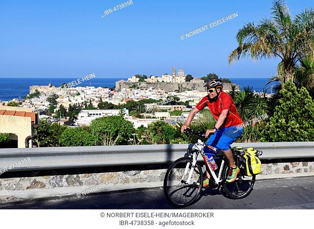 Cyclist above Lipari city, Aeolian Islands or Aeolian Islands, Sicily, Italy