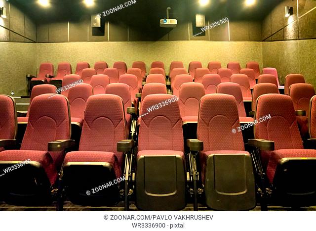 Empty seats in the small movie theater with cinema projector