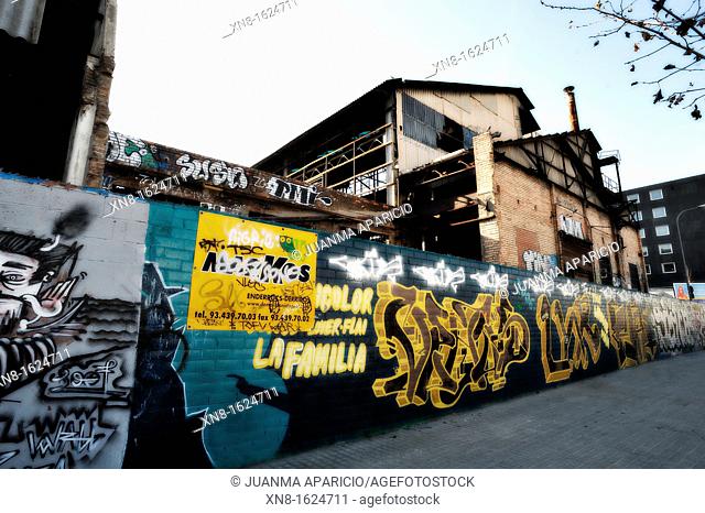 Graffiti on the exterior walls of an abandoned factory in Barcelona, ??photographed at dusk