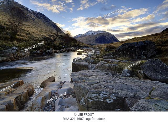 Winter view along partly-frozen River Etive towards distant mountains, Glen Etive, Rannoch Moor, near Fort William, Highland, Scotland, United Kingdom, Europe