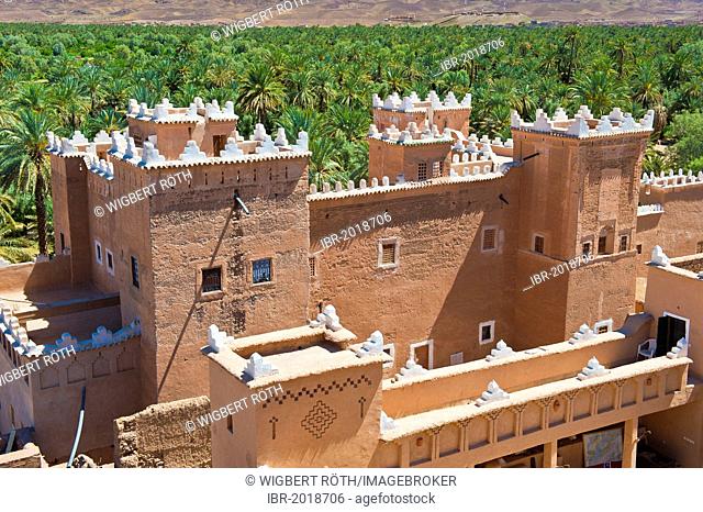 View of the restored towers of the Qaid Ali Kasbah, Asslim, and the adjoining palm grove, Agdz, Draa-Valley, Southern Morocco, Morocco, Africa