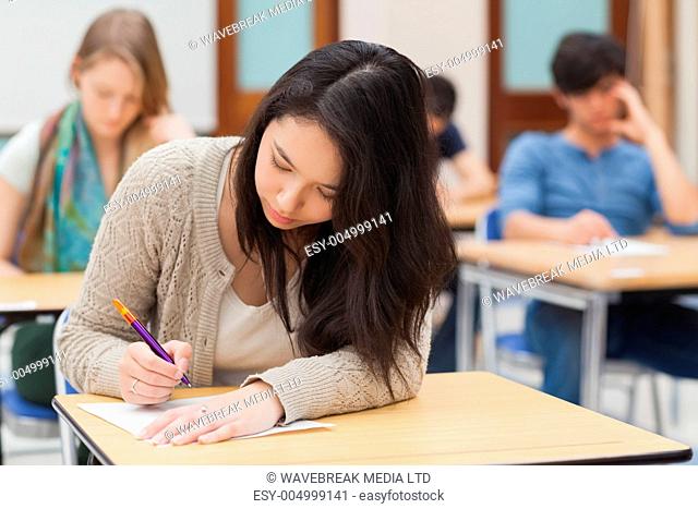 Woman doing an exam in exam hall in college