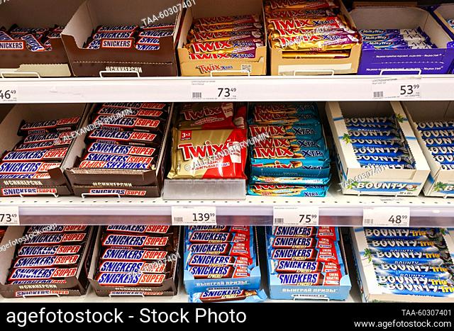 RUSSIA, RYAZAN - JULY 7, 2023: Snickers, Twix, Bounty and Milky Way chocolate bars by the US group Mars Incorporated on display in a shop