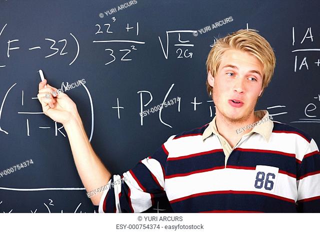 Education - Young man demonstrating algebra