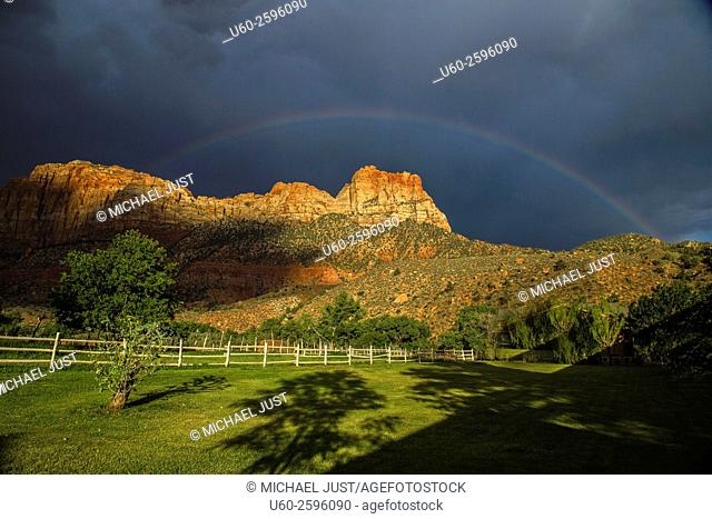 A thunderstorm passes through Zion Canyon and produces a rainbow at Zion National Park, Utah