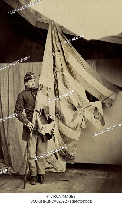 Unidentified Union Soldier Holding Tattered Flag of 37th Pennsylvania Infantry during American Civil War, USA, 1861