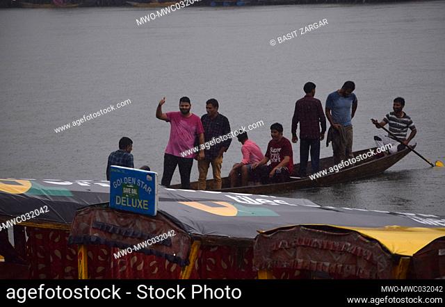 People crossing on a raft during heavy rains in Srinagar, India