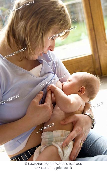 30 year old mother breastfeeding her 12 week old baby