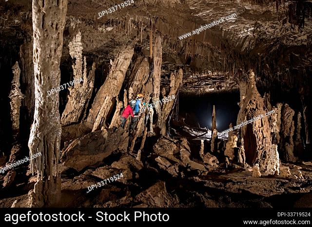 Researchers exploring stalagmites in a cave in Gunung Mulu National Park; Sarawak, Borneo, Malaysia