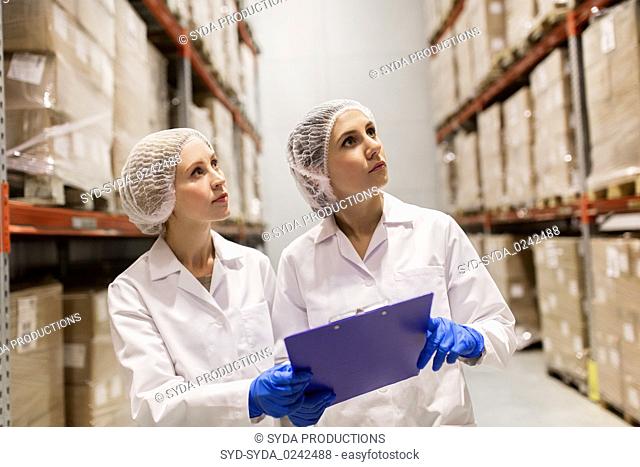 women technologists at ice cream factory warehouse
