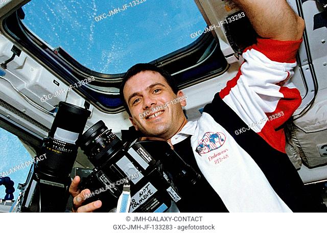 Astronaut Peter J. K. (Jeff) Wisoff, STS-68 mission specialist, is pictured with two Hasselblad cameras on the flight deck of the Space Shuttle Endeavour