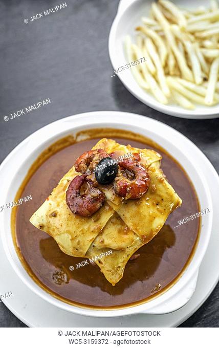 famous francesinha traditional meat cheese and spicy sauce grilled sandwich of porto portugal