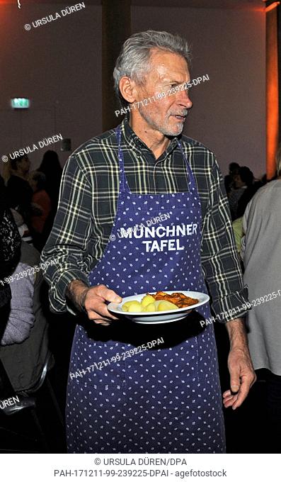 Former national soccer player Paul Breitner supporting the Munchner Tafel e.V. ('Munich Food Bank') during the distribution of food in the Old Bavarian State...