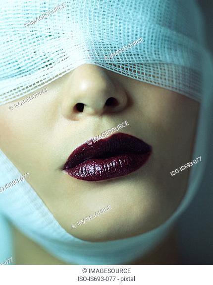 Woman wearing bandage and lipstick