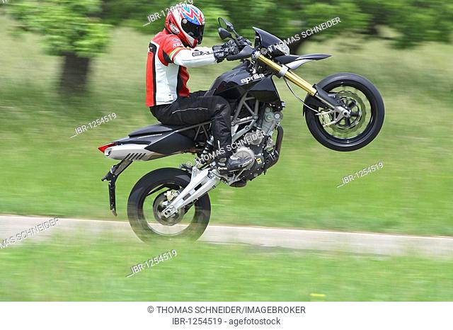 Aprilia Dorsoduro motorcycle in motion, wheelie