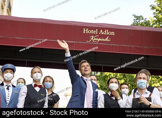 11 June 2021, Berlin: Michael Sorgenfrey (M), director of the Hotel Adlon Kempinski at Pariser Platz, stands in front of the hotel entrance together with...
