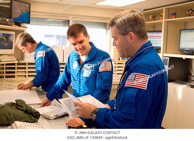 Astronauts Stephen N. Frick (foreground) and Rex J. Walheim, STS-122 commander and mission specialist, respectively, go over their flight plans in the check-out...