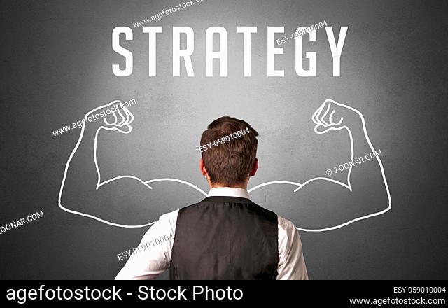 Rear view of a businessman with STRATEGY inscription, powerfull business concept