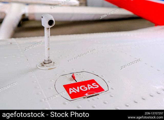Pitot probe on top of light aircraft wing, close up detail with fuel tank latch