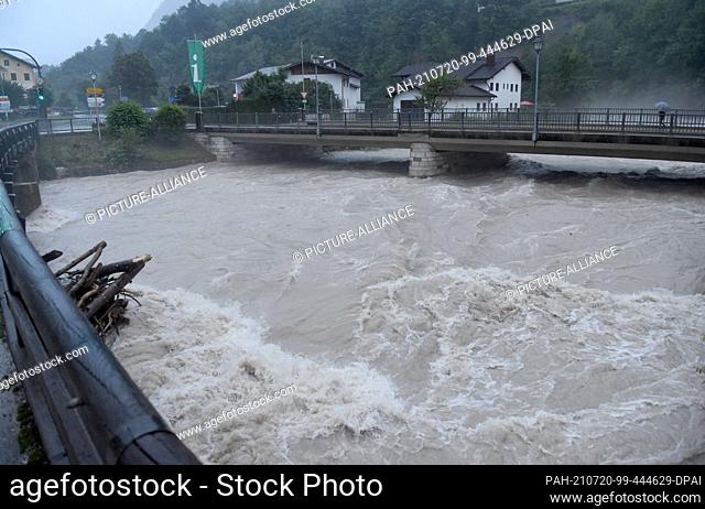 18 July 2021, Bavaria, Marktschellenberg: During storms and floods in Bavaria, many masses of water rush under bridges that lead over the Berchtesgadener Ache...