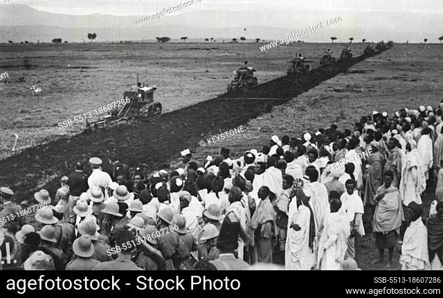 The Cultivation of Abyssinia.Natives at Fadis (Harar) watching the ***** hitherto barren land by tractor ploughs imported for ***** purpose from Italy