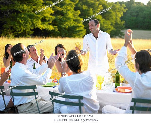Group of people having dinner, sunset