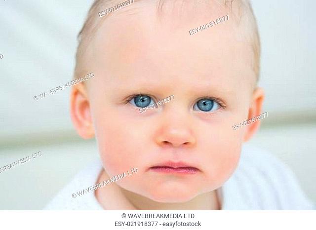 Close up of a baby looking at camera in living room