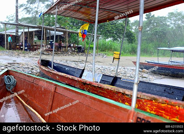 Boats at the Rio Napo in heavy rain, near Tena, Napo Province, Ecuador, South America