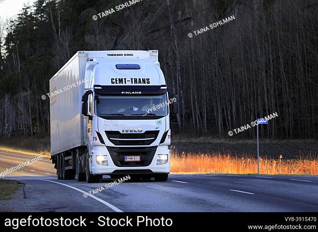 Biogas fueled Iveco Stralis NP truck Cemt-Trans Oy pulls refrigerated trailer along highway 52 on a sunny morning. Salo, Finland. November 26, 2020.