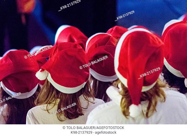 Children's choir in Santa's hats singing Christmas carols, Teatre Principal de Palma, Palau Reial, Palma, Majorca, Balearic Islands, Spain