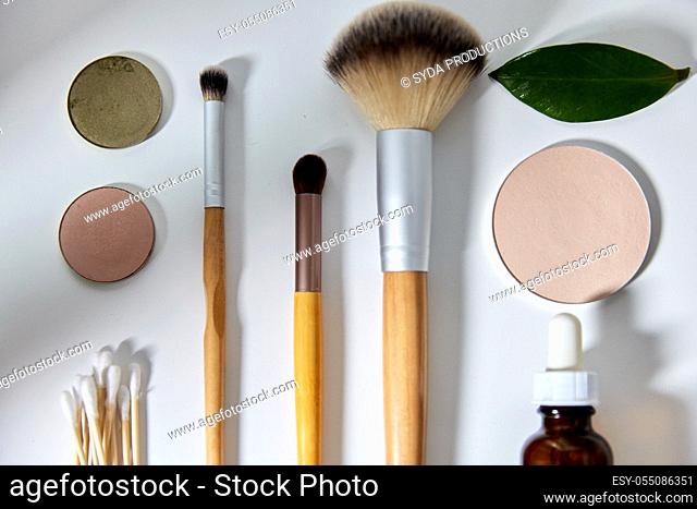 make up brushes, cosmetics and cotton swabs