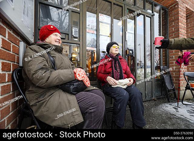 Stockholm, Sweden A group of active seniors and church members are served coffee outdoors in a coffee meet-up outside a local church in Grondal because of...