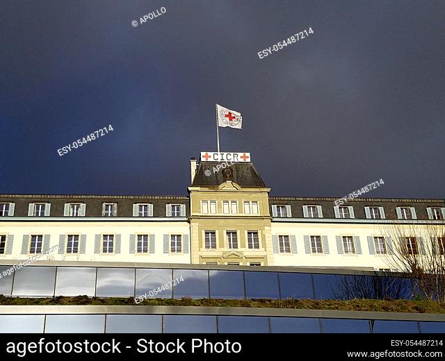 Dark storm clouds approaching the headquarters of the International Committee of the Red Cross, ICRC, with the Red Cross flag, Geneva, Switzerland