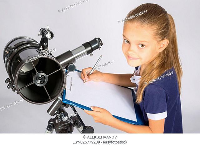 Young Astronomer writes the results of observations in the document