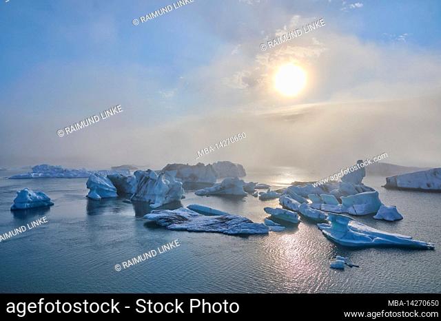 Glacier lagoon, ice, floes, fog, clouds, sun, evening, summer, Jokulsarlon, Austurland, Iceland