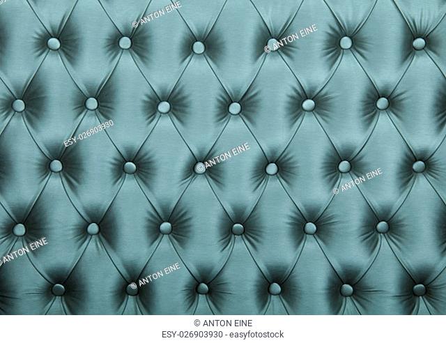 Silver blue teal capitone textile background, retro Chesterfield style checkered soft tufted fabric furniture diamond pattern decoration with buttons, close up