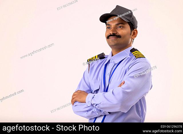 Portrait of Security guard looking elsewhere with arms folded