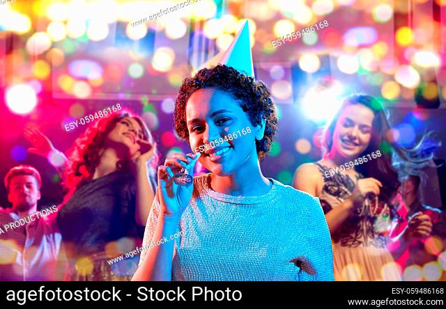 african woman with party blower at nightclub