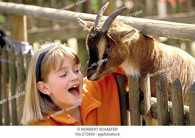 Portrait, outdoor, blond girl caress a goat  - DEUTSCHLDEU, 21/06/2006