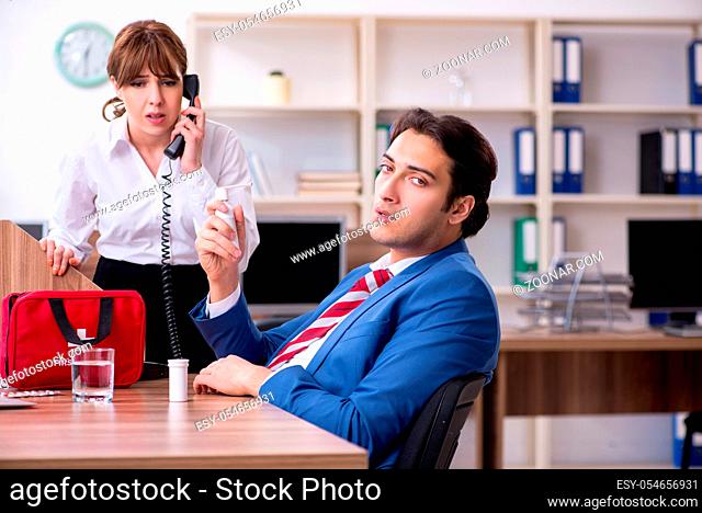 Employee receiving first aid in office