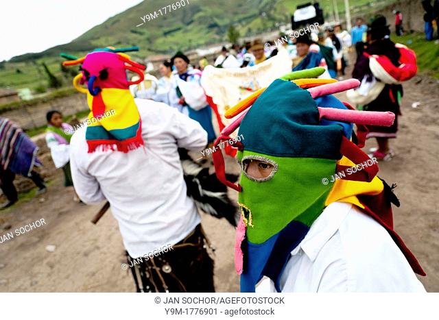 A man dancer, wearing a colorful masque of Aya Uma - the creature from the Indian myths, leads the procession during the Inti Raymi fiesta in Pichincha province