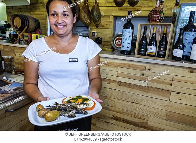 Portugal, Lisbon, Bairro Alto, Restaurante Adega de Sao Roque, restaurant, dining, Hispanic, woman, waitress, carrying food plate, working, interior
