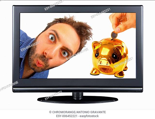 Young boy with a surprised expression in the tv with piggy bank