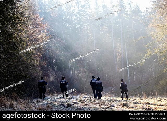 18 December 2023, Baden-Württemberg, Bingen-Hitzkofen: Police units are searching a wooded area for a two-year-old child who has been missing since Sunday...
