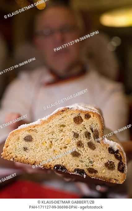 Michael Isensee, Stollen tester of the German Bread Institute, holds a stollen in his hands in Magdeburg, Germany, 27 November 2017