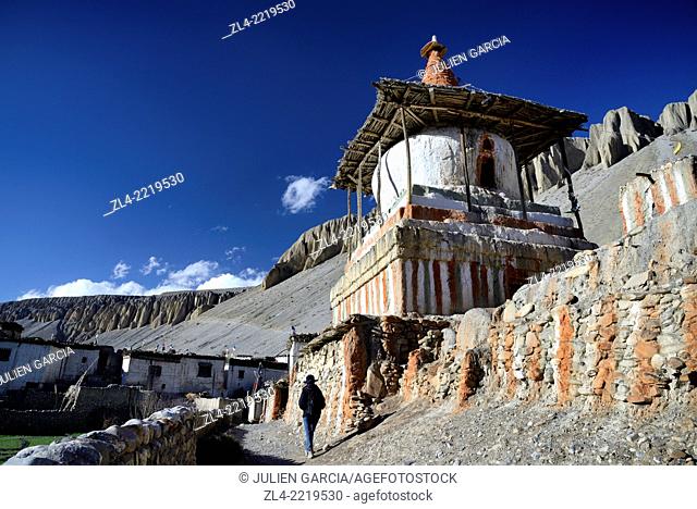 Mani wall (stones inscribed with a buddhist mantra) and stupa (chorten) in the village of Tangge. Nepal, Gandaki, Upper Mustang (near the border with Tibet)