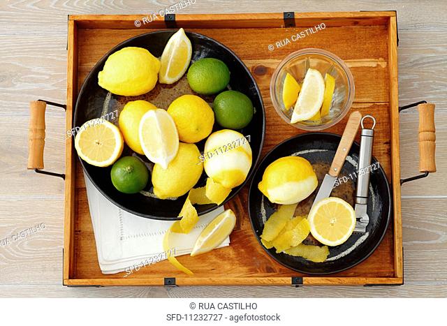 Lemons and limes (whole, cut in half, wedges and lemon peel)